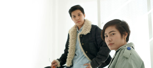 Portrait of mother and daughter standing at home