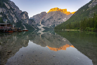 Scenic view of lake by mountains against sky