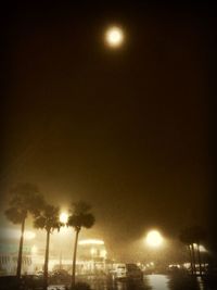 Low angle view of illuminated street light at night