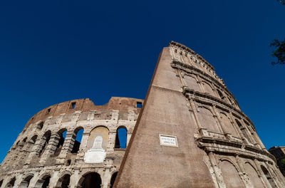 Low angle view of historical building against blue sky