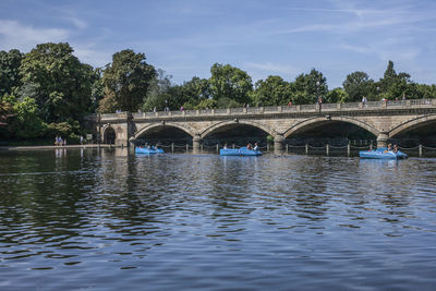 Arch bridge over river against sky