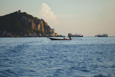 Longtail boat floating over blue sea of koh tao island thailand