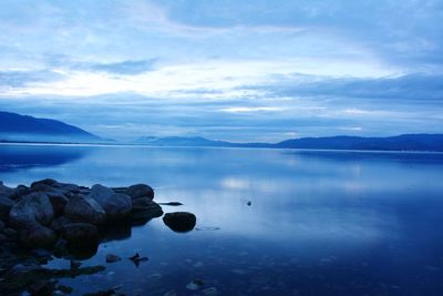 Scenic view of lake against cloudy sky