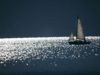 Sailboat sailing in sea against sky