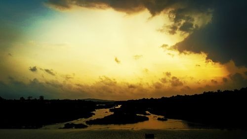 Scenic view of river against cloudy sky