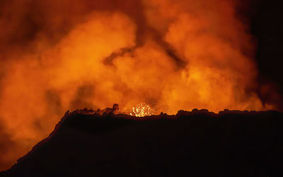 Low angle view of fire crackers against sky at night