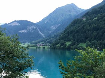 Scenic view of lake and mountains against sky