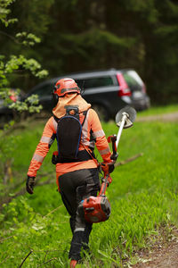 Female lumberjack walking on forest road