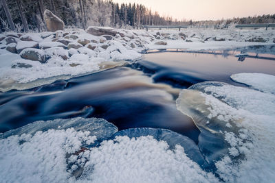 Frozen lake against sky during winter