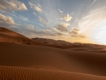 Scenic view of desert against sky during sunset