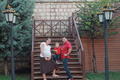 Rear view of people on staircase against building