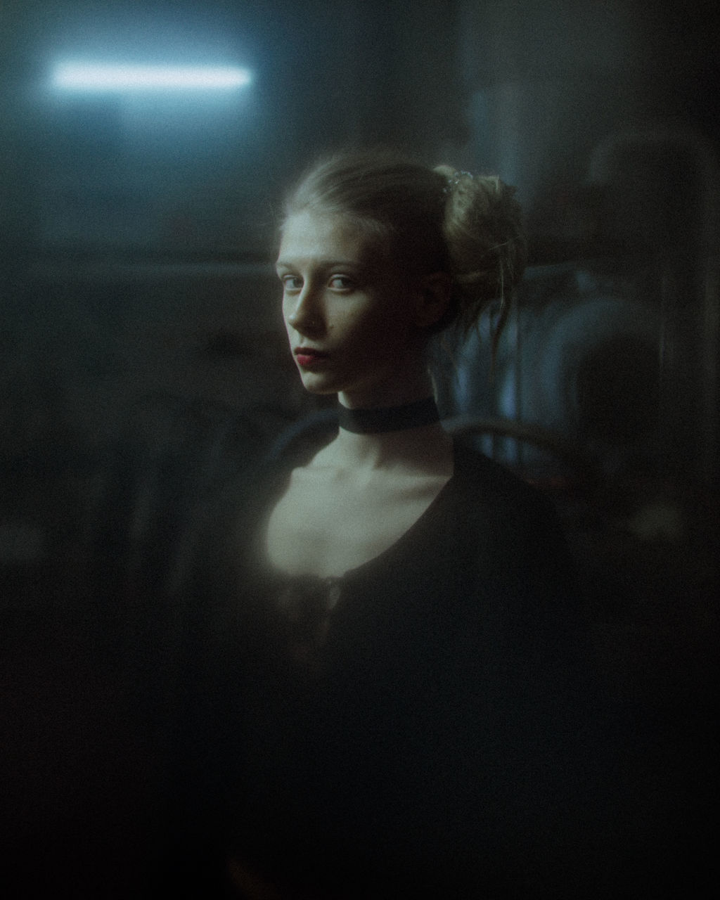 PORTRAIT OF BEAUTIFUL YOUNG WOMAN STANDING AGAINST CURTAIN