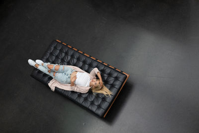 High angle portrait of woman lying on mattress