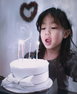 Close-up of cute girl in cake