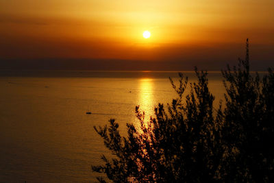 Scenic view of sea against orange sky