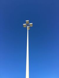 Low angle view of floodlight against clear blue sky