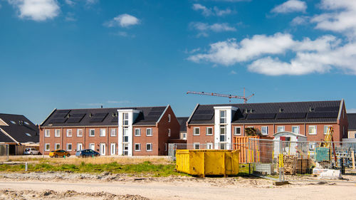 Houses on field against sky