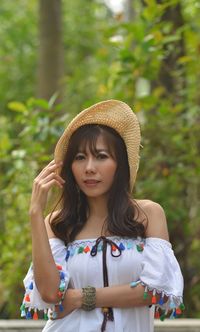 Portrait of woman standing in forest