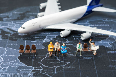 High angle view of people with toy on table