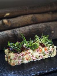 Close-up of olivier salad on slate