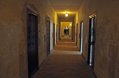 Rear view of people walking in illuminated building