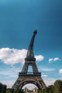 Low angle view of eiffel tower against cloudy sky