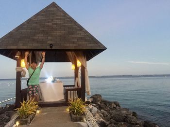 Built structure on beach against sky