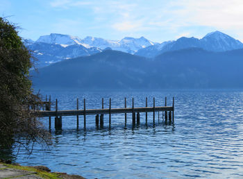 Pier over lake against mountains