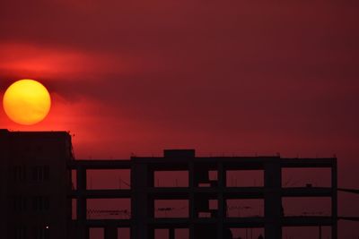 Red structure against sky at sunset