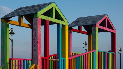 Multi colored umbrellas on beach against sky