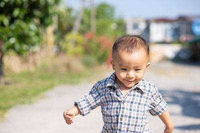 Portrait of cute boy standing outdoors