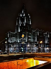 Illuminated city against sky at night