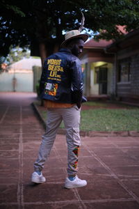 Rear view of man standing against wall