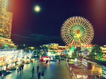 Illuminated ferris wheel at night