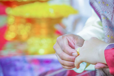 Cropped image of bride and bridegroom during engagement