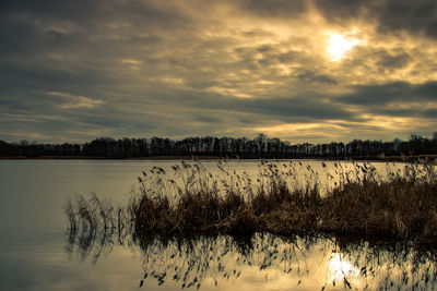 Scenic view of lake against sky during sunset