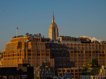 Buildings in city against clear sky