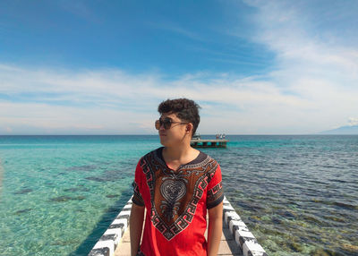 Man looking at sea against sky