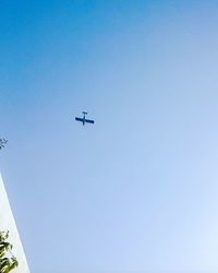 Low angle view of vapor trail against clear blue sky