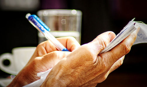 Close-up of hand holding mobile phone