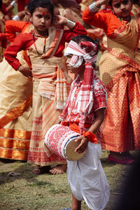 Rear view of woman standing in traditional clothing