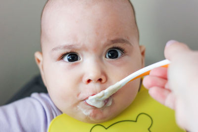 Feeding the baby. child eating by spoon baby food - vegetable puree