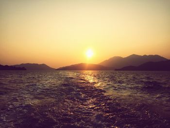 Scenic view of sea against clear sky during sunset