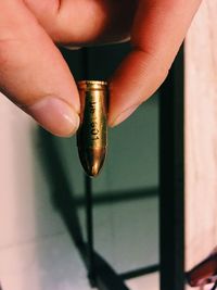 Close-up of hand holding bullet