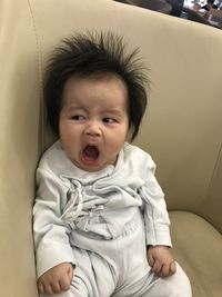 Portrait of cute baby girl on bed