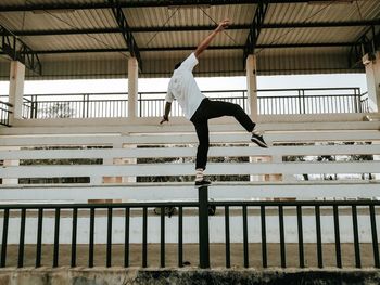 Full length of man jumping on railing
