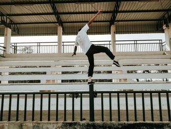 Man standing on fence 