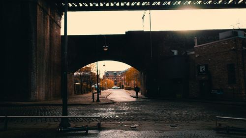 Arch bridge over street against clear sky