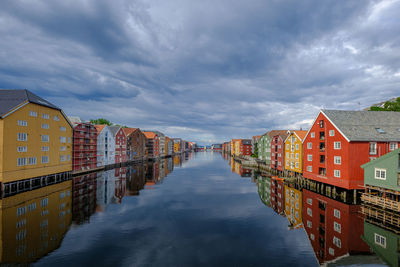 Illuminated buildings in city against sky