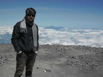 Full length of man standing on land against sky